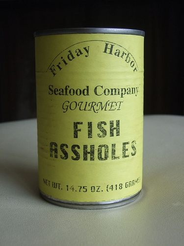 A yellow tin can labelled Gourmet Fish Assholes
